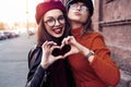 Outdoors fashion portrait young pretty best girls friends in friendly hug. Walking at the city. Posing at the street Royalty Free Stock Photo