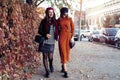 Outdoors fashion portrait young pretty best girls friends in friendly hug. Walking at the city. Posing at the street Royalty Free Stock Photo