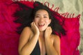 Outdoors fresh and natural portrait of young beautiful and happy Asian Korean woman in bikini lying flat on sarong on beach sand Royalty Free Stock Photo