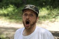 Outdoors horizontal portrait of happy hiker young man with red beard, feel good after hiking in forest. Traveler bearded male Royalty Free Stock Photo