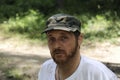 Outdoors horizontal portrait of happy hiker young man with red beard, feel good after hiking in forest. Traveler bearded male Royalty Free Stock Photo