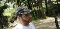 Outdoors horizontal portrait of happy hiker young man with red beard, feel good after hiking in forest. Traveler bearded male Royalty Free Stock Photo