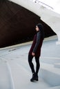 Outdoors lifestyle fashion portrait of Beautiful brunette woman wearing autumn clothes standing on white stairs Royalty Free Stock Photo