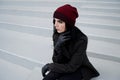 Outdoors lifestyle fashion portrait of Beautiful brunette woman wearing warm winter autumn clothes and knitted hat. Royalty Free Stock Photo