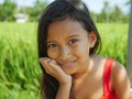 Outdoors lifestyle portrait of beautiful and sweet young girl smiling happy and cheerful the child with gorgeous eyes and dressed Royalty Free Stock Photo