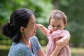 outdoors lifestyle portrait of mother and daughter - young happy and sweet Asian Korean woman playing with her 8 months baby girl Royalty Free Stock Photo