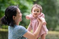 outdoors lifestyle portrait of mother and daughter - young happy and sweet Asian Korean woman playing with her 8 months baby girl Royalty Free Stock Photo