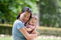 outdoors lifestyle portrait of mother and daughter - young happy and sweet Asian Korean woman playing with her 8 months baby girl Royalty Free Stock Photo