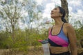 Outdoors lifestyle portrait of young attractive tired and thirsty Asian woman drinking water after hard running workout cooling Royalty Free Stock Photo