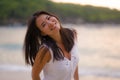 Outdoors lifestyle portrait of young beautiful and happy Asian Chinese woman in Summer dress enjoying cheerful walk at tropical Royalty Free Stock Photo