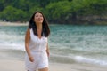 Outdoors lifestyle portrait of young beautiful and happy Asian Korean woman in Summer dress enjoying cheerful walk at tropical Royalty Free Stock Photo