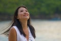 Outdoors lifestyle portrait of young beautiful and happy Asian Korean woman in Summer dress enjoying cheerful walk at tropical Royalty Free Stock Photo