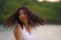 Outdoors lifestyle portrait of young beautiful and happy Asian Korean woman in Summer dress enjoying cheerful walk at tropical Royalty Free Stock Photo