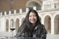 Outdoors lifestyle portrait of young happy and attractive Asian Chinese tourist woman enjoying wine glass sitting at cafe in Royalty Free Stock Photo