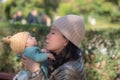 Outdoors lifestyle portrait of young happy and beautiful Asian Chinese woman as mother of little adorable baby girl holding her Royalty Free Stock Photo