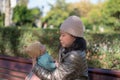Outdoors lifestyle portrait of young happy and beautiful Asian Korean woman as mother of little adorable baby girl holding her Royalty Free Stock Photo