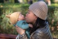 Outdoors lifestyle portrait of young happy and beautiful Asian Korean woman as mother of little adorable baby girl holding her Royalty Free Stock Photo