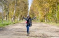 Outdoors lifestyle portrait of young happy and pretty Asian Chinese woman jumping carefree and cheerful at beautiful city park in Royalty Free Stock Photo