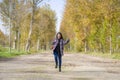 Outdoors lifestyle portrait of young happy and pretty Asian Chinese woman jumping carefree and cheerful at beautiful city park in Royalty Free Stock Photo