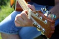 Outdoors, a man plays the guitar on a sunny day Royalty Free Stock Photo