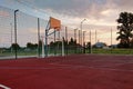 Outdoors mini football and basketball court with ball gate and basket surrounded with high protective fence Royalty Free Stock Photo