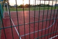 Outdoors mini football and basketball court with ball gate and basket surrounded with high protective fence Royalty Free Stock Photo