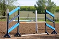 Outdoors photo of wooden barriers for jumping horses. Preparation of horses for performance on equestrian training Royalty Free Stock Photo