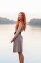 Outdoors portrait of beautiful smiling woman with red hair, colo Royalty Free Stock Photo
