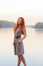 Outdoors portrait of beautiful smiling woman with red hair, colo Royalty Free Stock Photo