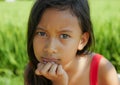 Outdoors portrait of beautiful and sweet 8 years old young girl looking with intense gorgeous eyes to the camera, the child in a Royalty Free Stock Photo