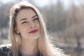 Outdoors portrait of beautiful young brunette girl. Woman smiling happy on sunny summer or spring day outside on city background. Royalty Free Stock Photo