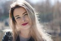 Outdoors portrait of beautiful young brunette girl. Woman smiling happy on sunny summer or spring day outside on city background. Royalty Free Stock Photo