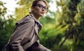 Outdoors portrait of beautiful young woman in casual clothes posing in autumn garden. Royalty Free Stock Photo