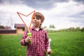 Outdoors portrait of cute preschool boy blowing soap bubbles on a green lawn at the playground Royalty Free Stock Photo