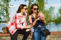 Outdoors portrait of female friends drinking coffee and having fun. Royalty Free Stock Photo