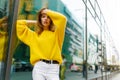 Beauty portrait of a grace, sensual girl with brown hair, posing with attitudine in street, looking at camera.