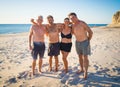 Group of mature happy active adults having fun in the beach. Long time friends Royalty Free Stock Photo