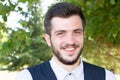 Outdoors portrait of handsome happy young man smiling broadly posing smiling and looking at the camera Royalty Free Stock Photo