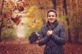 Outdoors portrait of happy young man standing in autumn park at Royalty Free Stock Photo