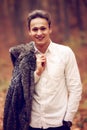 Outdoors portrait of happy young man standing in autumn park at Royalty Free Stock Photo