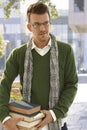 Outdoors portrait of male student with books Royalty Free Stock Photo