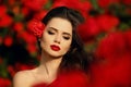 Outdoors portrait of Natural Beauty woman in red roses. Sensual Royalty Free Stock Photo