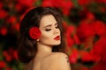 Outdoors portrait of Natural Beauty woman in red roses. Sensual Royalty Free Stock Photo