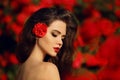 Outdoors portrait of Natural Beauty woman in red roses. Sensual Royalty Free Stock Photo