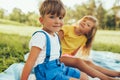 Outdoors portrait of smiling children playing on the blanket. Cute little boy and little girl relaxing in the park. Adorable kids Royalty Free Stock Photo