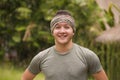 Outdoors portrait of young attractive and happy hipster man enjoying tropical nature exploring exotic Asian tourist destination Royalty Free Stock Photo