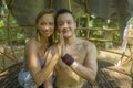 Outdoors portrait of young beautiful and happy couple practicing yoga workout together at tropical forest gazebo smiling cheerful Royalty Free Stock Photo