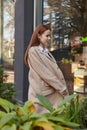 Outdoors portrait of young Caucasian red headed girl in coat with long hair Royalty Free Stock Photo