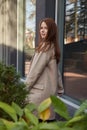 outdoors portrait of young caucasian red headed girl in coat with long hair Royalty Free Stock Photo