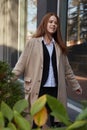 outdoors portrait of young caucasian red headed girl in coat with long hair Royalty Free Stock Photo